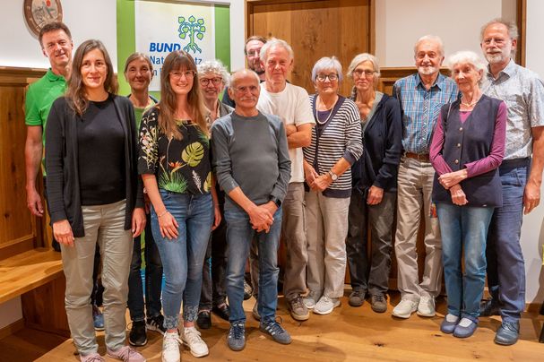 Die Aktiven der Ortsgruppe zusammen mit Kreisgruppenvertretern stehen im Versammlungslokal zusammen für das Gruppenfoto